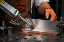 Handheld laser welding thin stainless steel sheet with copper backing for heat control