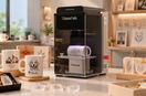 Xlaserlab UV laser engraving a ceramic plate beside personalized plates and clear keepsakes in a gift shop