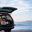 Xlaserlab Q1 portable laser cleaner and engraver in SUV trunk beside travel cases