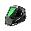 Black welding helmet with green visor and side adjustment knob, isolated on black background.
